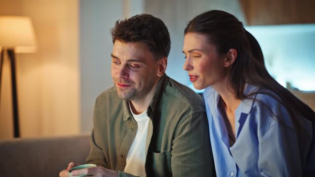 Cheerful duo laughing evening atmosphere closeup. Enamoured pair looking laptop