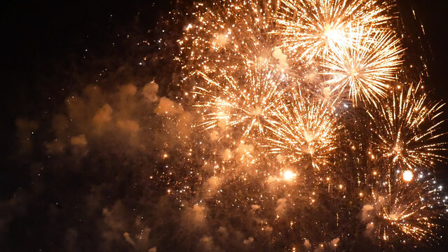 Golden Firework celebrate anniversary happy new year 2023, 4th of july holiday festival. Gold firework in the night time celebrate national holiday. Countdown to new year 2023 gold party time event
