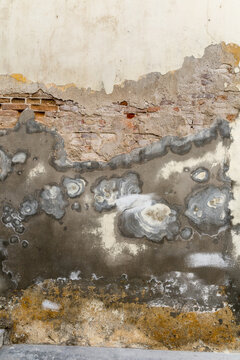 Cuba, Cienfuegos.  Layers of brick, plaster and stucco peeling off a wall.