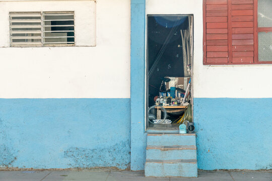 Cuba, Cienfuegos. An informal plumbing and housewares shop in residential doorway.  Part of the not-so-hidden black market.