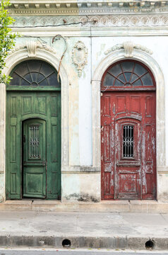 Cuba, Cienfuegos.  Red and green entrance doors to homes on the main street.