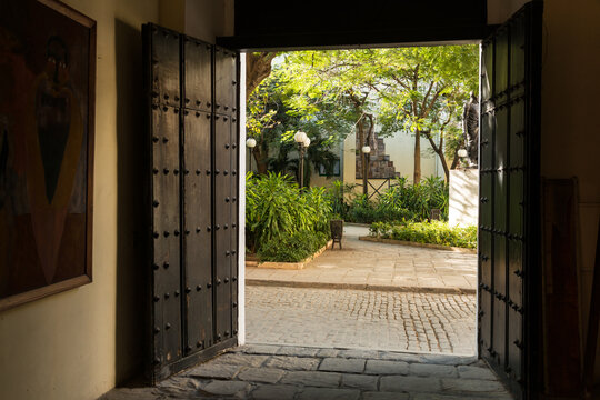 Cuba, Cienfuegos.  Doorway opens up to a beautiful courtyard.