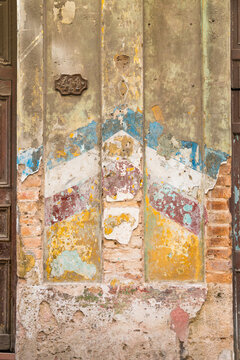 Cuba, Cienfuegos.  The tarnished remnants of old paint on the exterior wall of residential building in old Havana