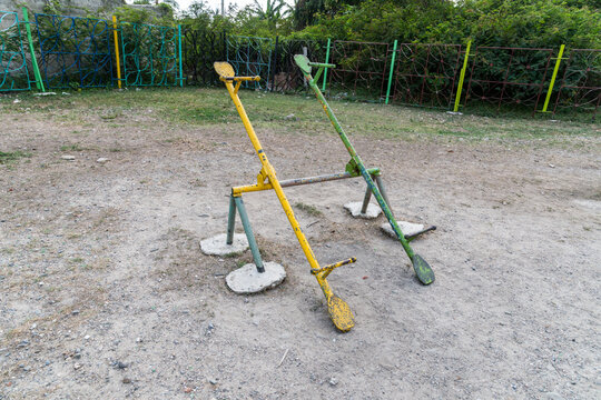 Cuba, Cienfuegos.  An uncomfortable looking seesaw ride in children's playground.