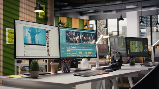 No people highlights workstation with video editing software on footage project, PC shows raw recorded clips and toolbar icons, effects panels and adjustment controls. Film production agency work.