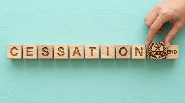Woman places final wooden block with cessation and end on a light blue surface
