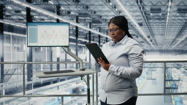 Reviewing schematics, semiconductors and portrait of smiling woman in smart factory. Overseeing layouts, EDA software and cheerful african american businesswoman in industry 4.0 plant, camera A