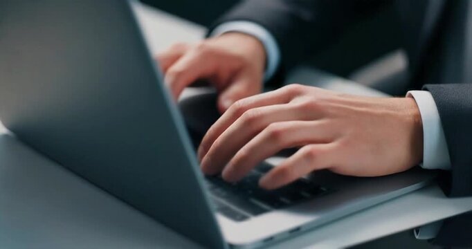 Close up of man hands typing on laptop keyboard in office working video footage.