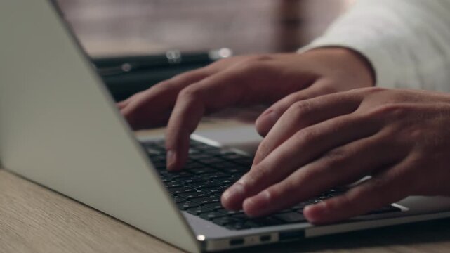 Close up unrecognizable Caucasian business man typing on laptop keyboard in office male hands businessman worker using computer internet technology programmer developer executive digital work online