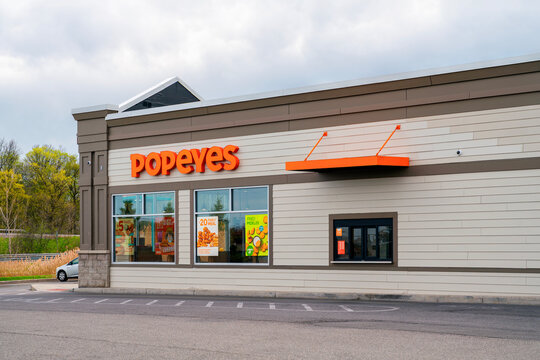 Camillus, NY - Apr 18, 2026: Exterior of a Popeyes Louisiana Kitchen restaurant in Township 5 Plaza. Popeyes, founded in 1972 and operated by Inspire Brands, has more than 3,900 locations worldwide