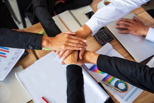 Business Hands stack together team teamwork partner corporation. Financial Planner hand holding teams partnership growing economy. Personal financial planner. Office firm team investment advice plan