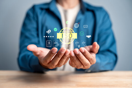Person holding international standard certification digital icon. Quality control and global standardization concept.