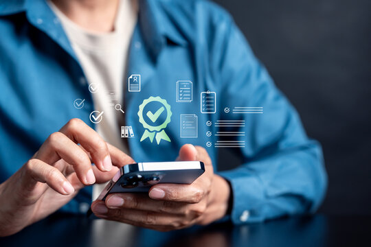 Person using smartphone with quality assurance certification hologram. Compliance, standard and digital document verification concept.