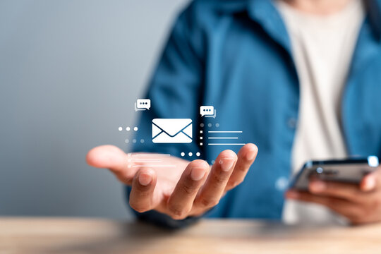 Person holding digital email and message icon. Communication, newsletter and customer support business concept.