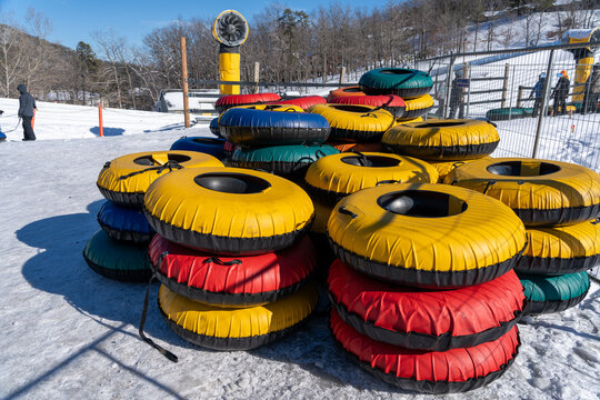 Stacks of colorful inner tubes for snow tubing at a resort