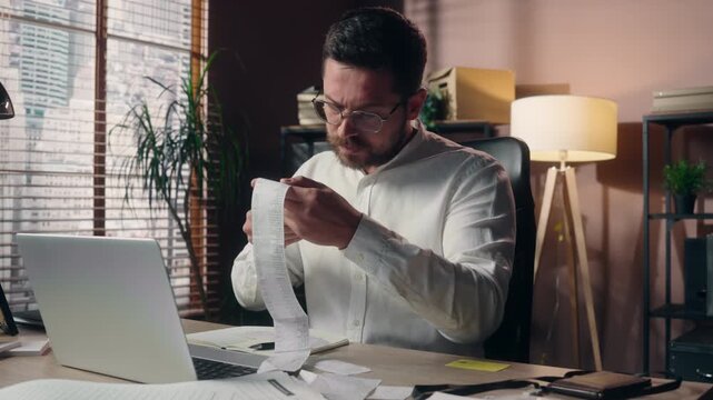 Worried Caucasian business man holding bill inside office stressed mature male employee reading financial documents money loss bankruptcy anxious businessman worker corporate accountant finance desk