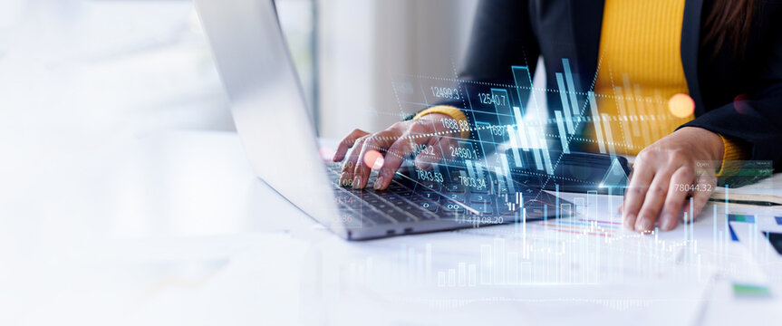 Close-up of businesswoman hands typing on laptop with overlaying complex financial chart, data analytics, and numbers finance and investment Business Financing Accounting Banking Concept.