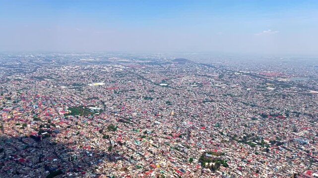 High-altitude aerial view of the infinite urban sprawl in Mexico City, massive residential density, 4K D-Log 