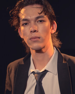 This dramatic close-up of a young man elicits strong emotions and showcases artistic impact, capturing the nuanced expression and intensity in a visually striking moment.
