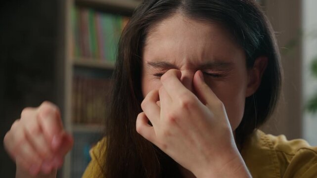 Tired exhausted Caucasian female student taking off glasses suffering eye strain headache young woman study university class overworked girl education stress fatigue vision problem itchy eyes indoors