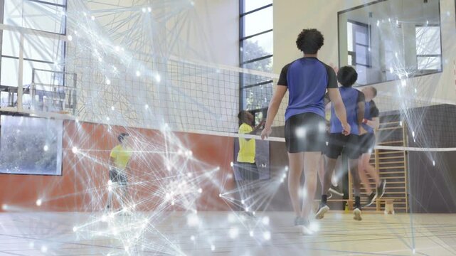 Volleyball players serving left, rallying at net to regain ball, particle web overlaying players