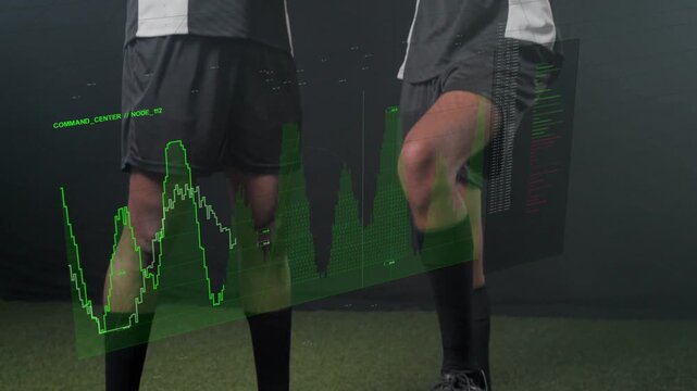 Two soccer players placing foot on ball in dark studio, HUD overlaying body analyzing training data