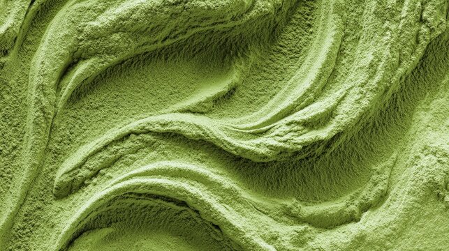 Flowing textured surface of green matcha powder forming a dynamic natural background, ideal for health, food, or branding visuals with organic texture and soft motion feel.