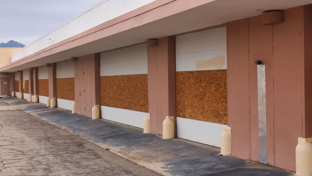Abandoned building with boarded windows and doors