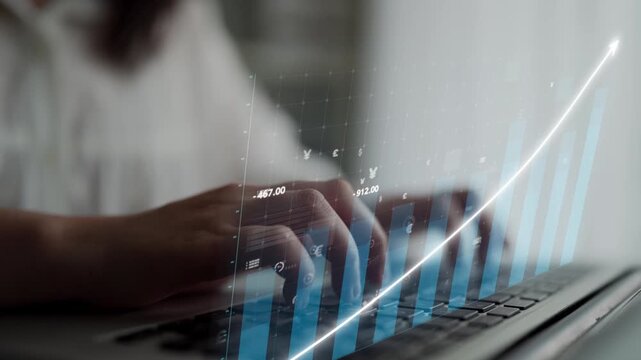 A close-up view of hands typing on a laptop, featuring a digital financial graph and currency symbols overlay, symbolizing growth and contemporary investment strategies. Copula