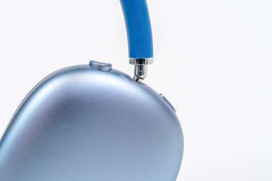 Rostov, Russia - April 04, 2022: An extreme close-up of a single blue metallic ear cup from Apple AirPods Max wireless headphones showing the smooth aluminum surface and headband connector