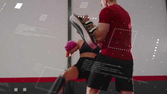Female boxer stepping and doing front kicks to coach with pads, boxing training overlays appearing