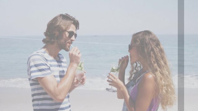 Man and woman raising straws and sipping on beach, activating animated cucumber icons for marketing