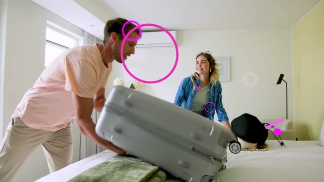 Couple entering hotel checking-in placing bags man tapping remote case slipping hugging she sitting