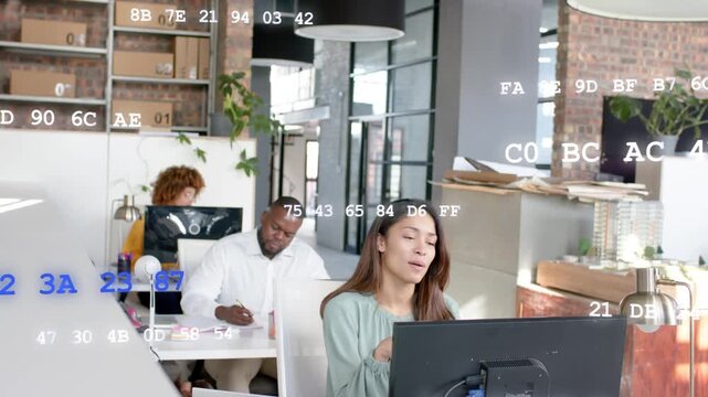 Lead woman starting tech meeting at monitor gesturing while team noting hex code overlaying scene