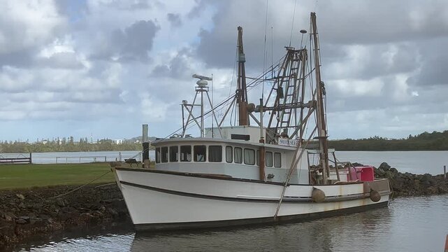 An Australian commercial fishing trawler docking on Haistings River NSW Australia.Trawler is a specialized vessel designed to pull large nets (trawls) through the water 