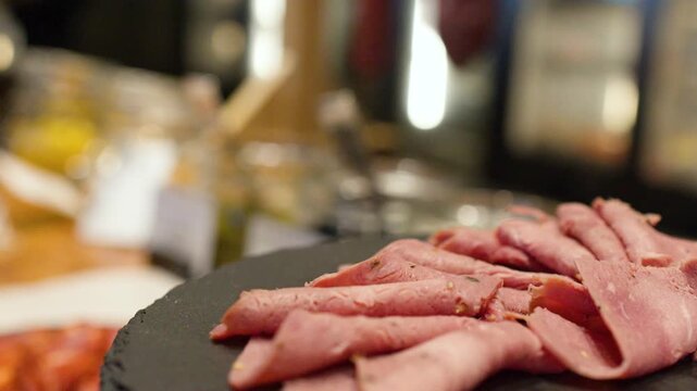 Close Up of Sliced Roast Beef on a Black Slate Platter