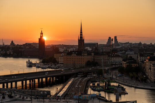 Sunset view towards Gamla Stan in Stockholm with transit and the sun behind towers