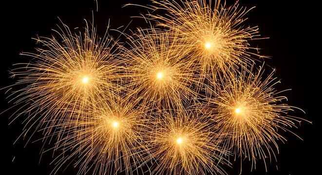 Golden fireworks bursts exploding in the night sky