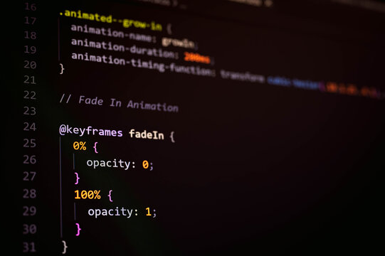 Close up of CSS animation code on computer screen showing keyframes, opacity transition and frontend development. Concept of web design, user interface motion and modern digital technology.