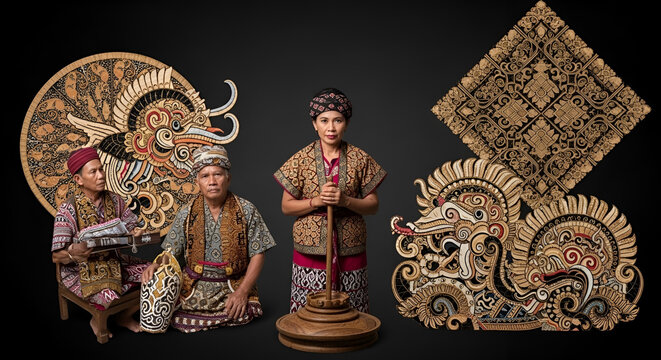 Traditional Balinese dancers in ornate costumes posing with ceremonial artifacts against a dark backdrop