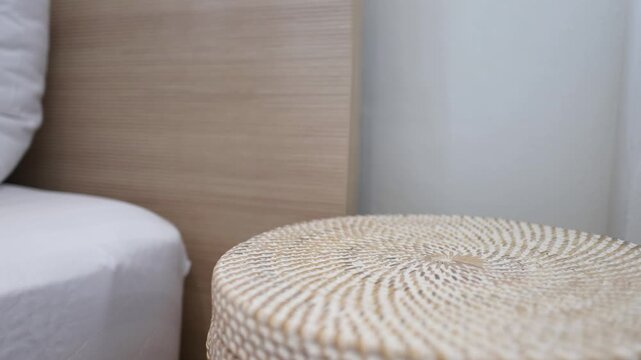 Person Reaching for Alarm Clock on Bedside Table in Morning