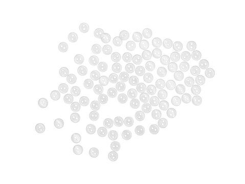 Top-view of many small white plastic buttons scattered on Transparent background, minimal studio flat lay with copy space.