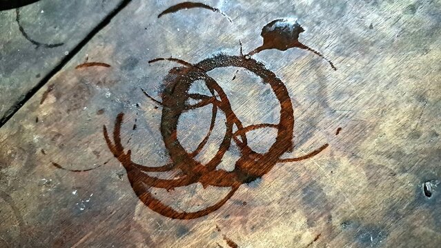 Coffee Cup Ring Stains on Rustic Wooden Table Surface, Brown Spill Marks and Messy Splatter on Wood, Cleaning and Maintenance Concept for Cafe Lifestyle with Copy Space.