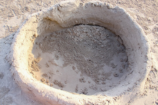 Ghost crab hole in sculpting sand bathtub on beach