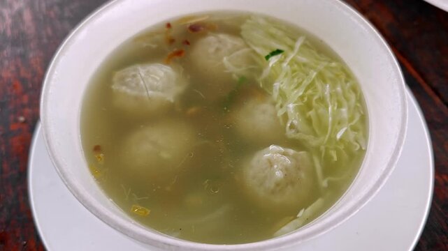 Traditional Indonesian Bakso Meatball Soup with Cabbage and Clear Savory Broth