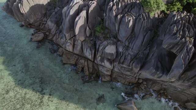Majestic drone footage of unique granite boulders meeting turquoise waters and lush jungle at Anse Grosse Roche, La Digue 011 30fps
