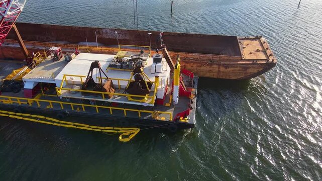 Dredging barge operating near Anclote River Park, Florida in a waterway, USA