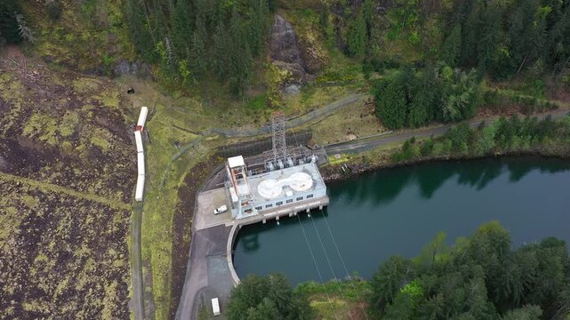 4K aerial drone footage of Yale Lake dam and hydroelectric power plant on the Lewis River in Washington, USA. Wide view of reservoir, forested hills and flowing water in Pacific Northwest landscape
