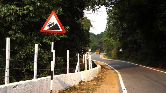 Road sign in the mountains says 'Steep grade ahead' or 'Uphill climb ahead'