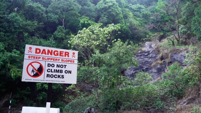 danger do not climb on rocks sign board